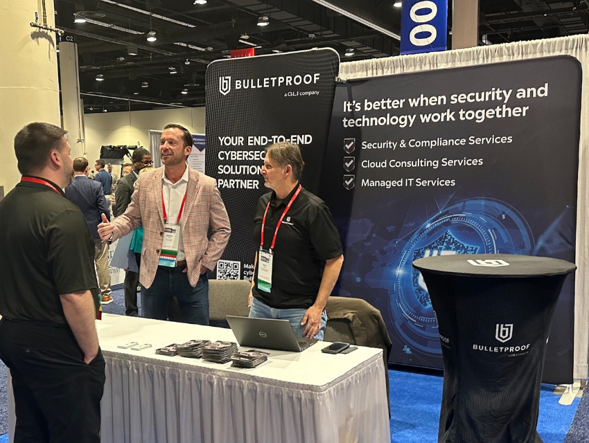 Bulletproof team engaging attendees at a 10x10 pop up booth using portable trade show displays