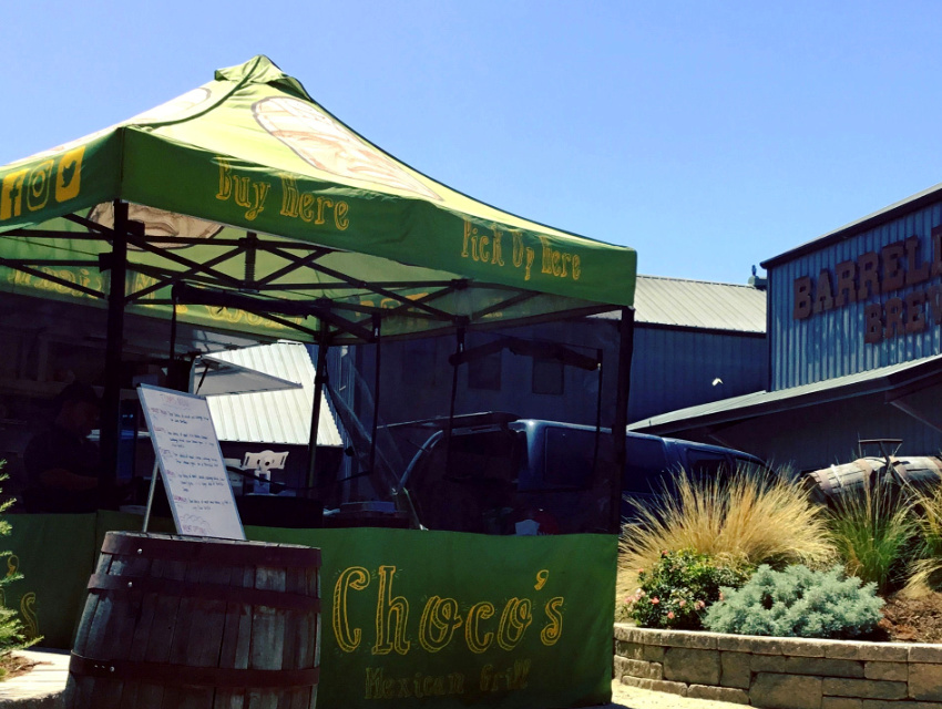 Choco’s Mexican Grill 10x10 food tent with bright green canopy, serving window, and social media icons on the valance