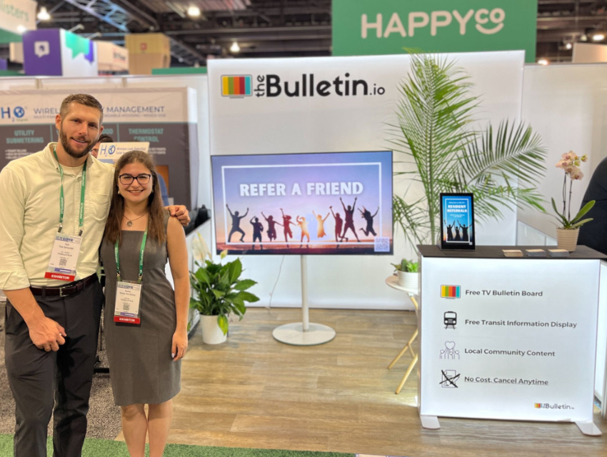 Small trade show booth with a backlit expo booth backdrop and matching illuminated counter that defines the space and brand message