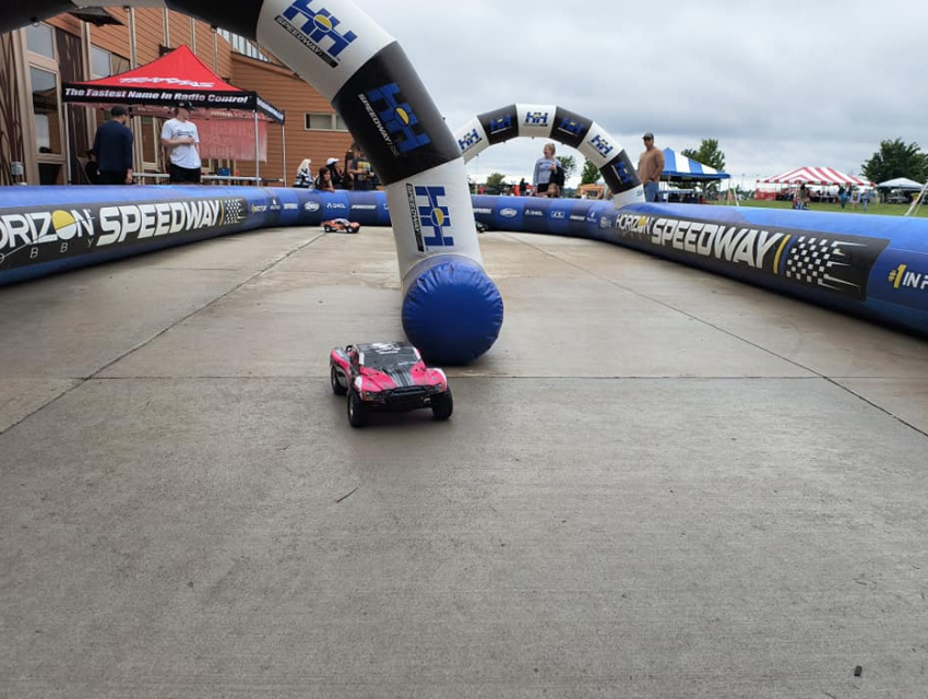 Custom inflatable RC track for Horizon Hobby at Motorama with branded archway and RC vehicle in action