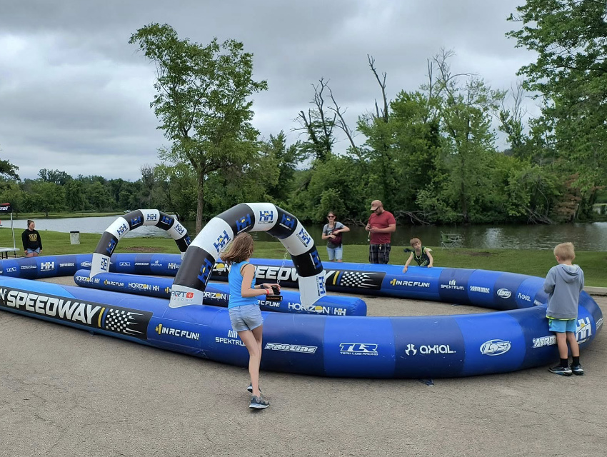 Family-friendly custom inflatable race track activation allowing attendees to test RC vehicles