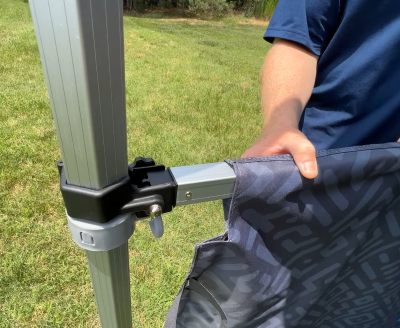 Close-up of a half height wall bracket and support bar secured to the tent leg.    