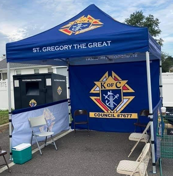 Parishioners dropping off food donations under Knights of Columbus tent