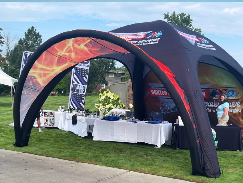 20x20 Spider Tent X1 inflatable event tent with double-sided door wall and printed extended awning at an outdoor event