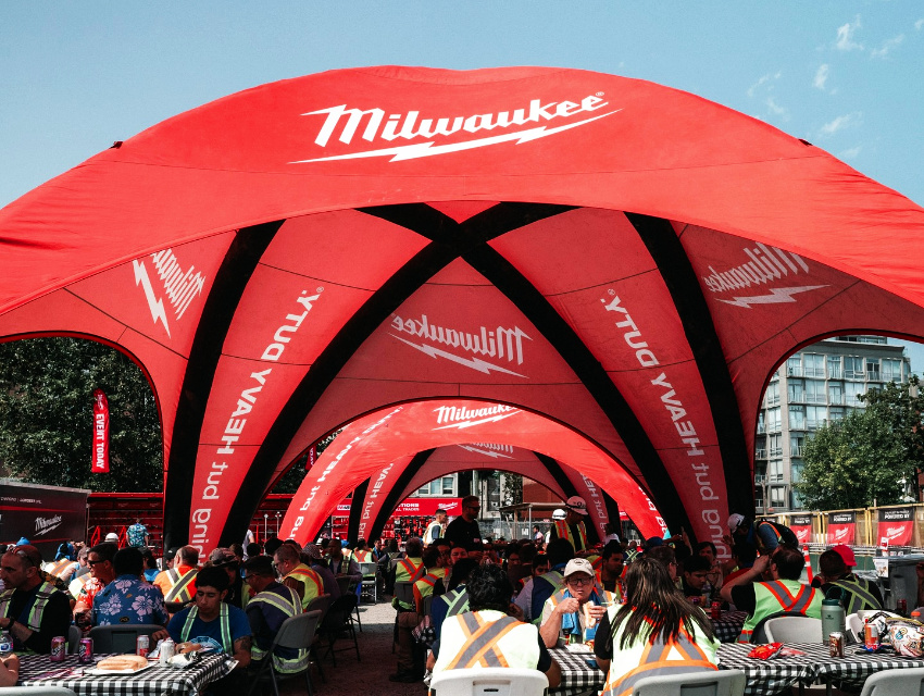 26x26ft Spider Tent X1 Pro inflatable event tent with custom Milwaukee Tool branding at a large outdoor event