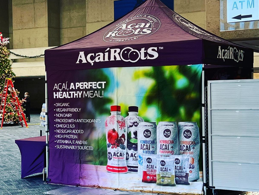 Custom tent with fully printed back wall and canopy showcasing bold, dye-sublimated graphics for indoor events