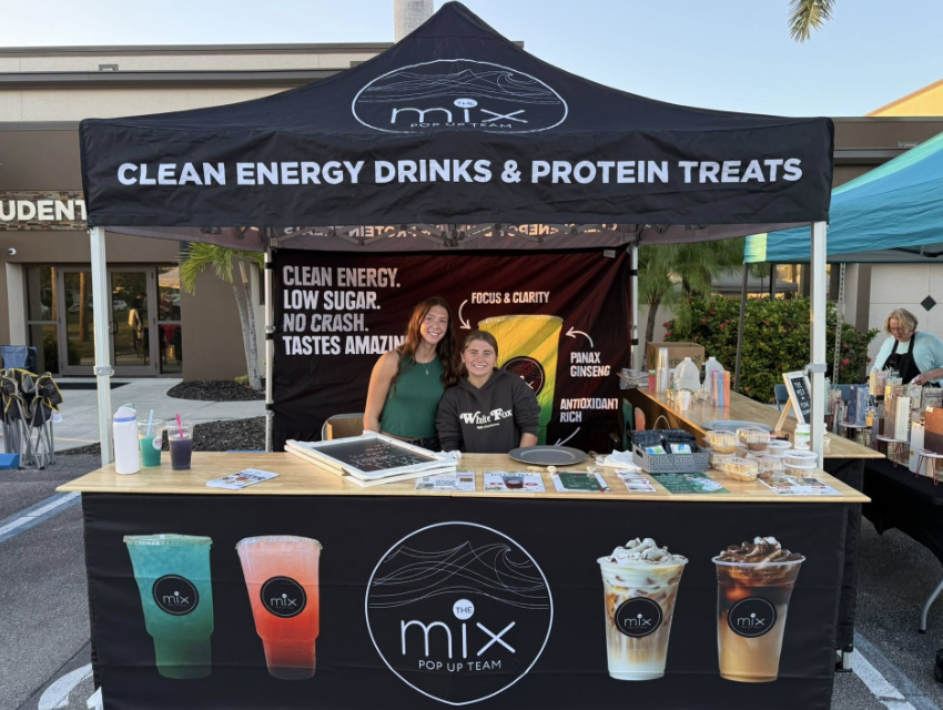 Vendor Pro tent setup for The Mix pop-up beverage brand with printed canopy, counters, and cohesive branding